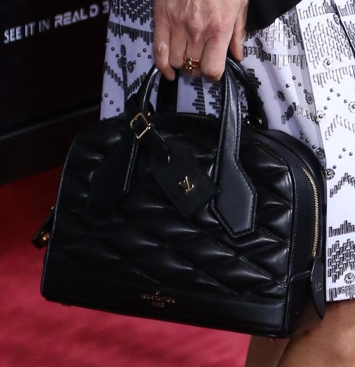 Jennifer Connelly toting a black quilted handbag