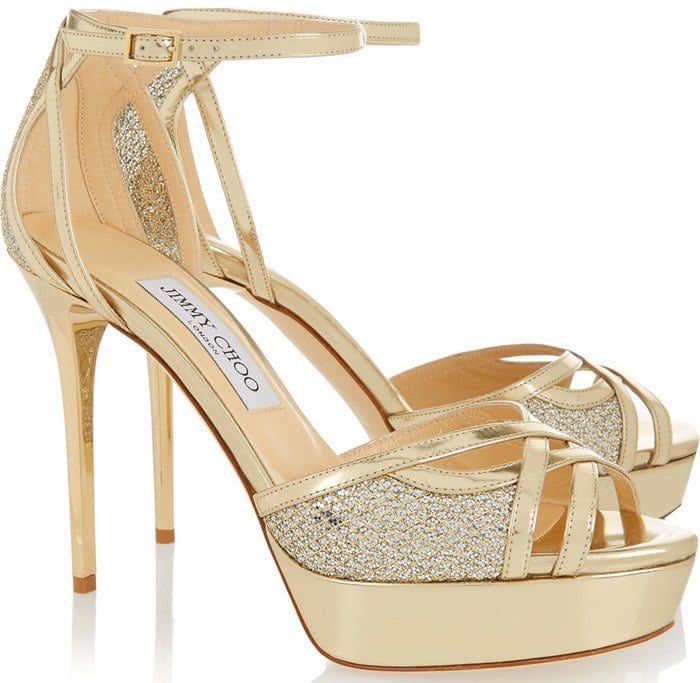 This gold metallic leather sandal has cutout crossover straps and glittered panels
