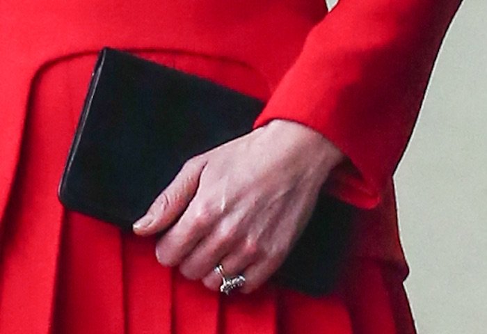 Kate Middleton accessorizes with a black clutch and her sapphire wedding ring