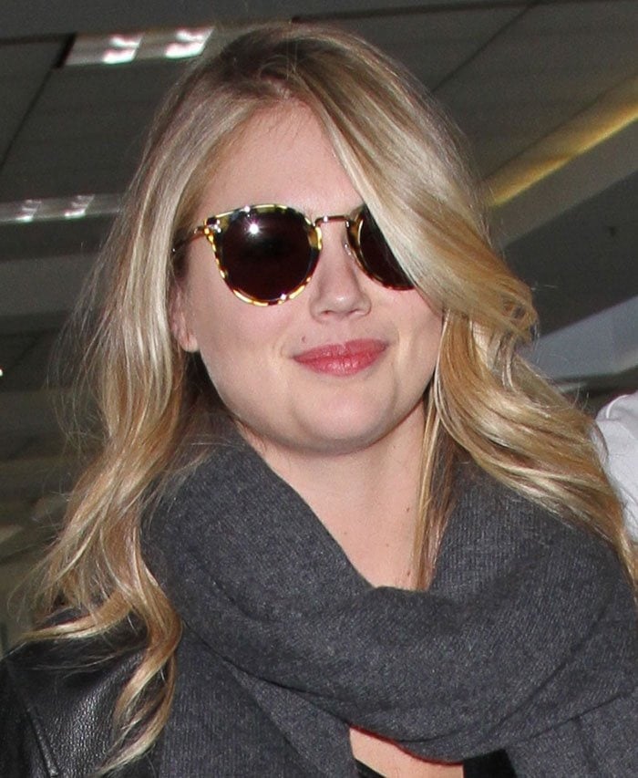 Kate Upton wears her hair down as she catches a flight at Los Angeles International Airport