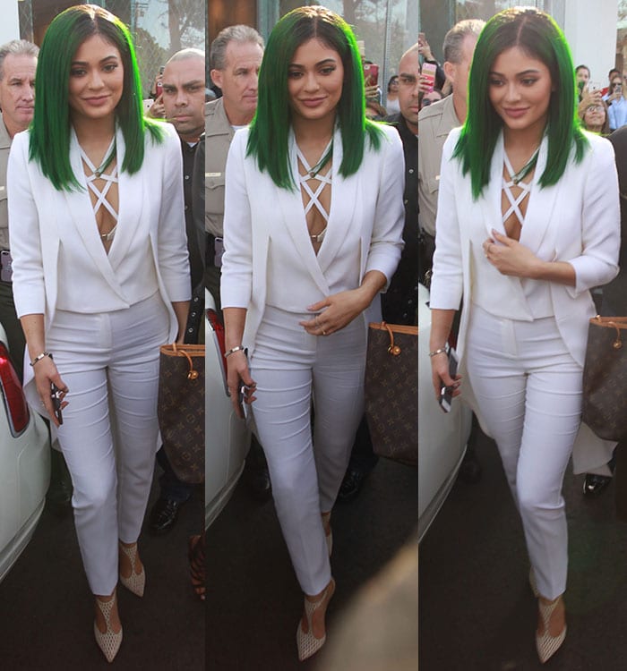 Kylie Jenner's green hair pops against a long white Olcay Gulsen tailcoat and a pair of white pants