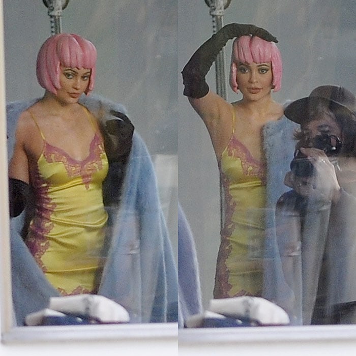 Kylie Jenner sporting a molded pink wig and pink-and-yellow slip dress for a photoshoot at Milk Studios