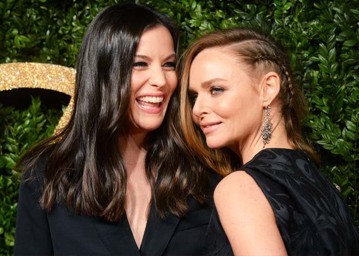 Liv Tyler and designer Stella McCartney pose for photos at the British Fashion Awards