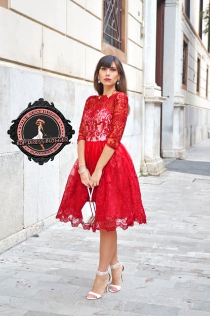 Maria Grazia is classy in a red lace dress with silver-and-white high heel sandals