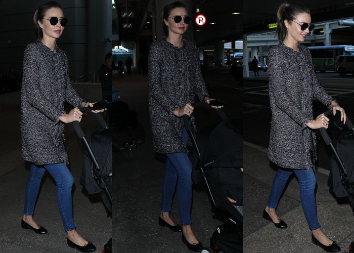 Miranda Kerr wears a coat and jeans as she arrives at LAX