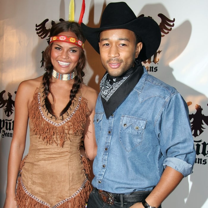 Musician John Legend (R) arrives with girlfriend Chrissy Teigen at the Pur Jeans Halloween Bash