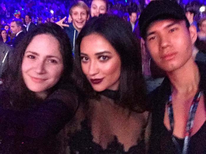 Via Shay Mitchell's Instagram: "Getting in the holiday spirit ... Thanks for having me Jingle Ball...! And thanks to the cutest photo bombers in the back 😜"