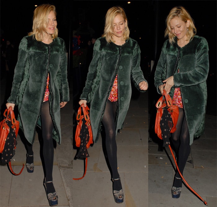 Sienna Miller totes a red Chloé Paraty handbag that features a distinctive triangular shape