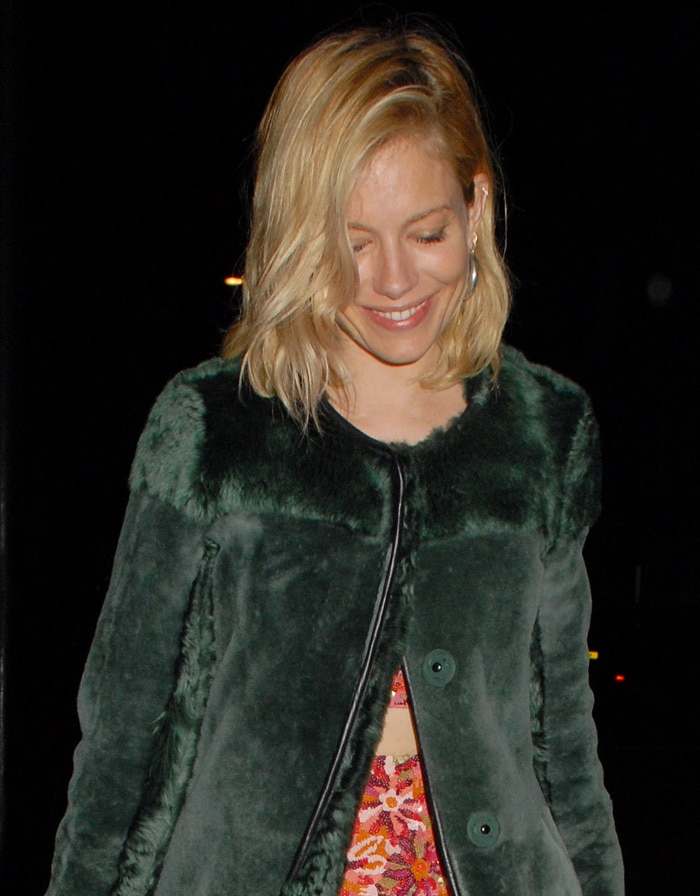 Sienna Miller in a green fur coat at the LOVE Magazine – Christmas party