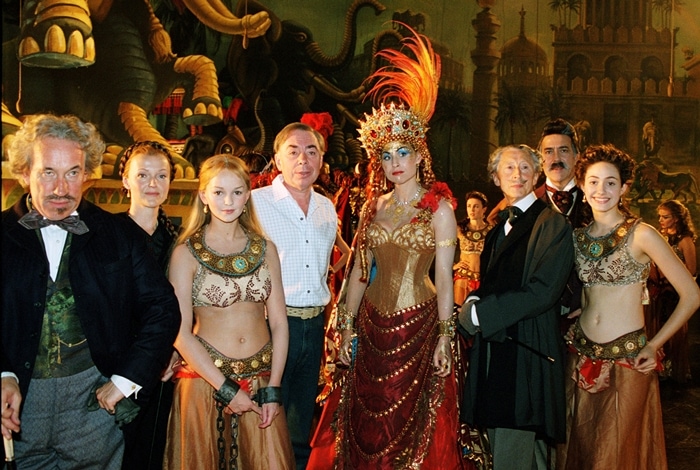 Simon Callow (as Andre), Miranda Richardson (as Madame Giry), Jennifer Ellison (as Meg Giry), composer/screenwriter/producer Andrew Lloyd Webber, Minnie Driver (as Carlotta), Murray Melvin (as Reyer), Ciarán Hinds (as Firmin), and Emmy Rossum (as Christine) in The Phantom of the Opera, a 2004 musical drama film based on Andrew Lloyd Webber's 1986 musical of the same name