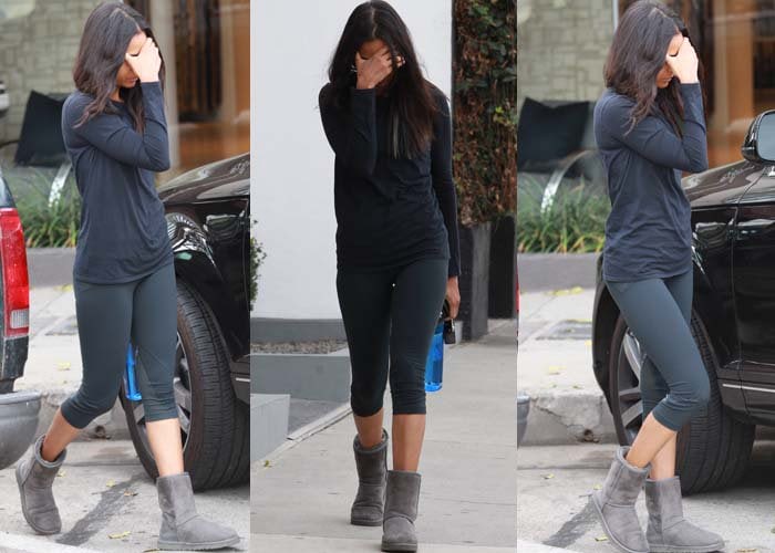 Zoe Saldana covers her face as she leaves her house