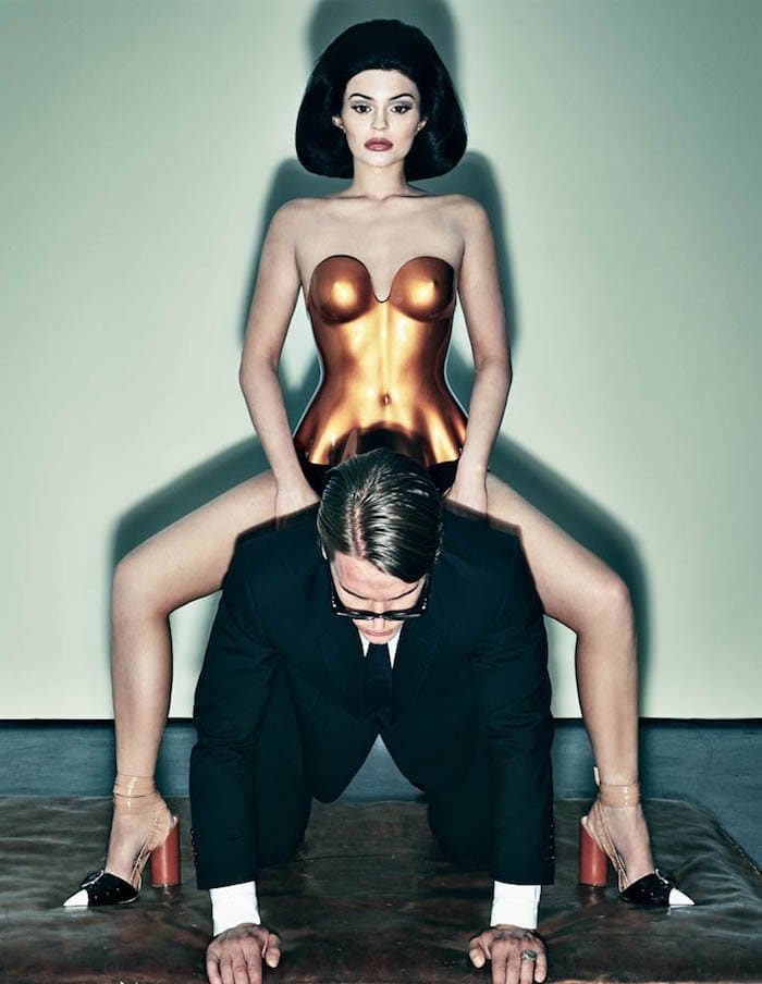 Kylie Jenner wears another wig and a gold body cast as she straddles a man for a photoshoot