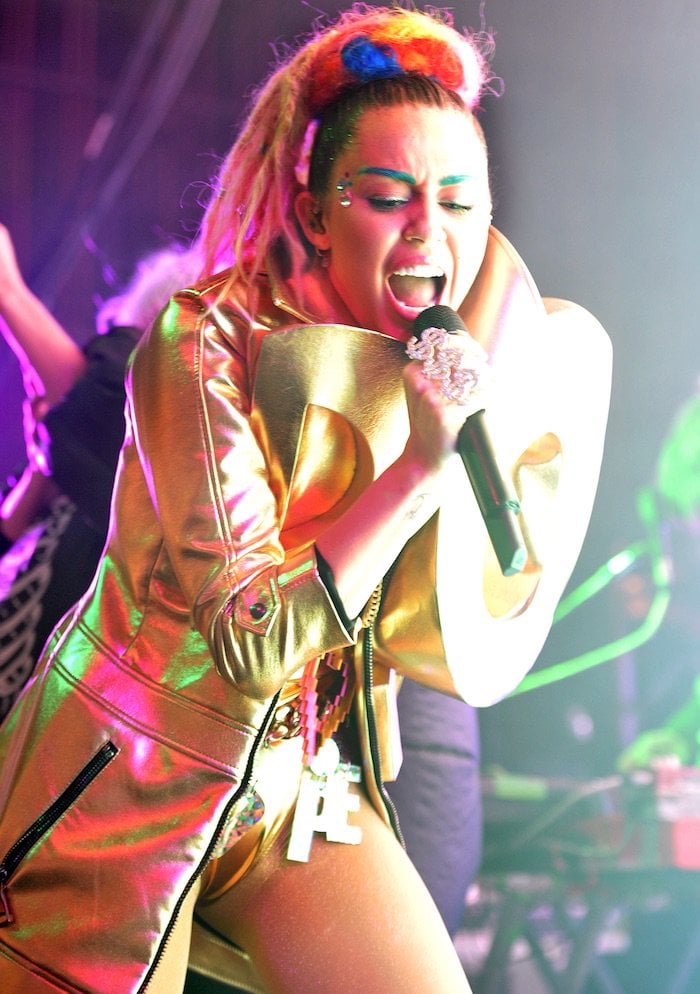 Miley Cyrus wears faux blonde dreadlocks in her hair during a performance at Chicago's Riviera Theatre