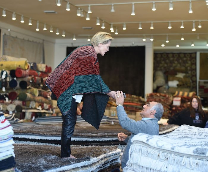 Sharon Stone ditches her mules to test out rugs while shopping