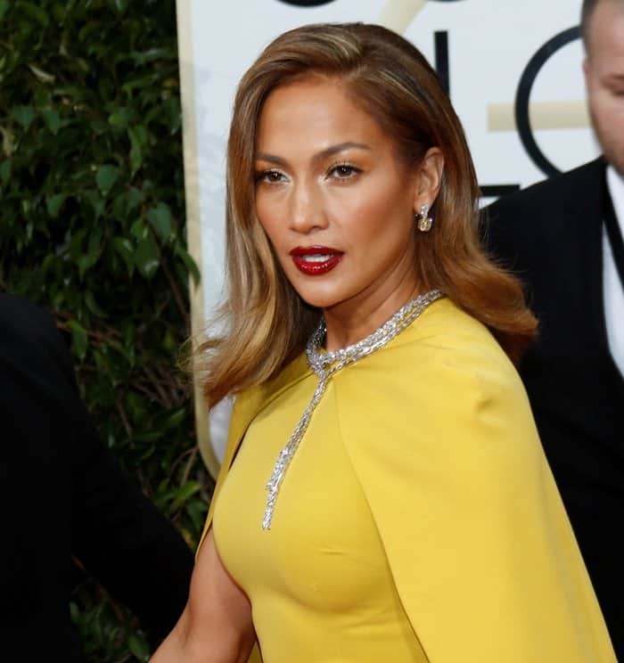 Jennifer Lopez exudes confidence as she showcases her sleek waves and a dazzling diamond necklace that perfectly complements her chartreuse gown at the 2016 Golden Globe Awards