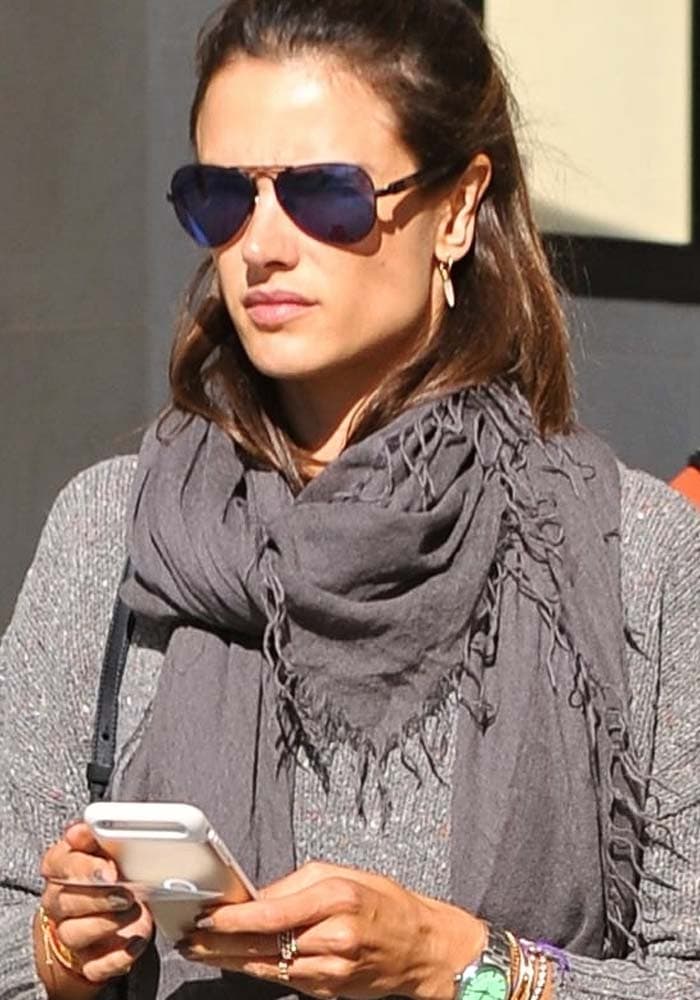 Alessandra Ambrosio wearing sunglasses and a long scarf