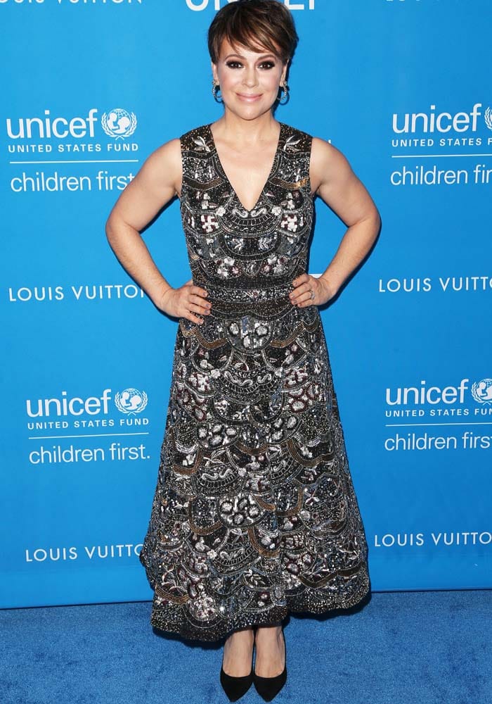 Alyssa Milano graces the blue carpet in an intricately embellished Alice + Olivia dress during the UNICEF x Louis Vuitton ball, advocating for children's welfare