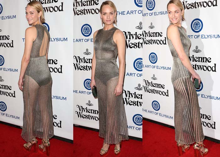 Amber Valletta wears a sheer striped gown from Vionnet Paris on the red carpet