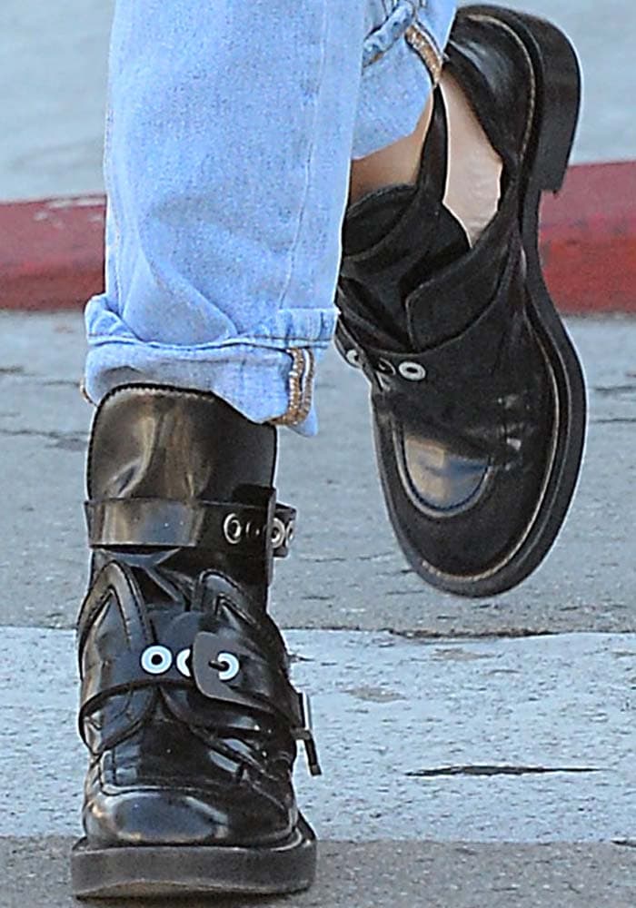 Ashley Benson wears a pair of buckled black boots from Balenciaga