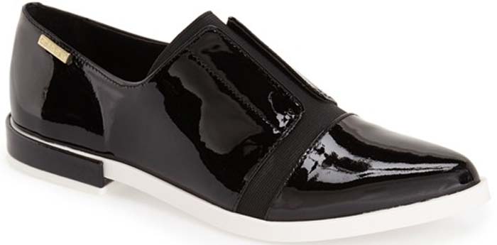 A scene-stealing, borrowed-from-the-boys oxford in liquid-shine patent leather gets refreshed with tonal elastic goring taking the place of classic lacing at the vamp