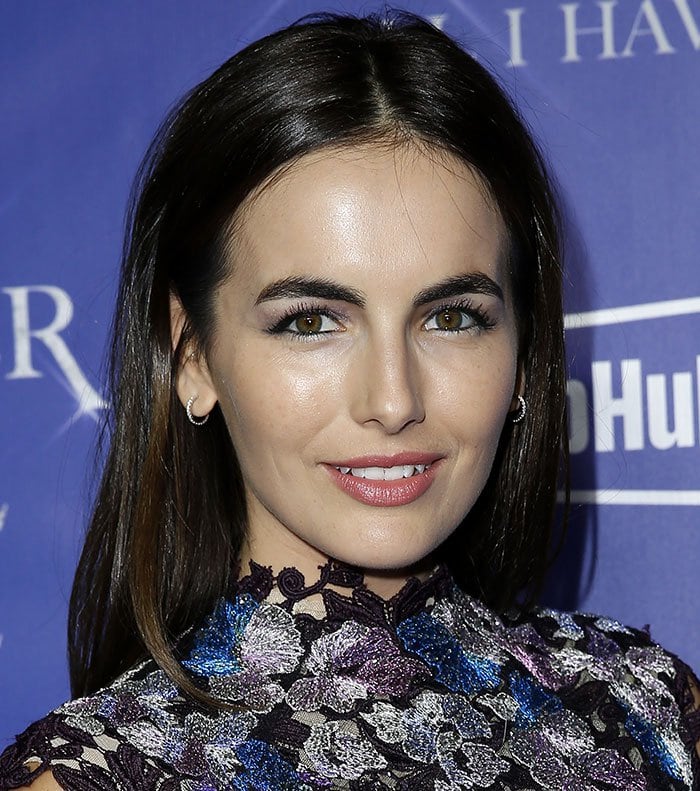 Camilla Belle enchants with a radiant smile, wearing a lace dress adorned with floral sequins