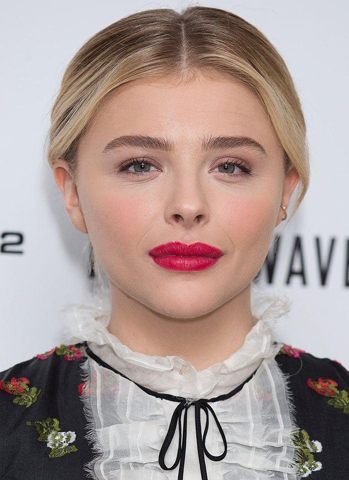 Chloë Grace Moretz pairs a bold red lip with a vintage-inspired floral Erdem dress featuring a delicate ruffled lace collar at The 5th Wave photocall in London