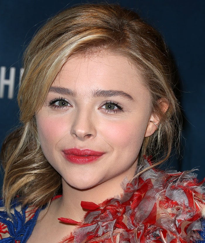 Chloe Grace Moretz clips her hair back at the AwesomenessTV special fan screening of "The 5th Wave"