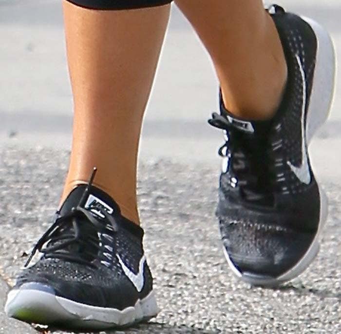 Chrissy Teigen wears gray Nike Flyknit Zoom Agility shoes