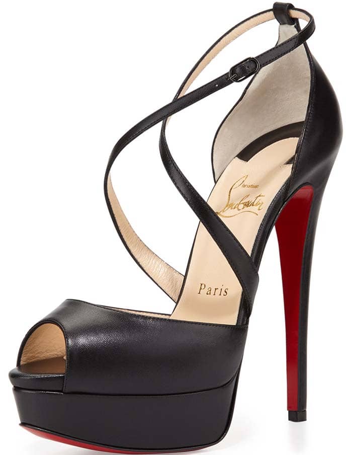 Crafted of black smooth kidskin, Christian Louboutin's Cross Me platform sandals are designed with a slim stiletto heel