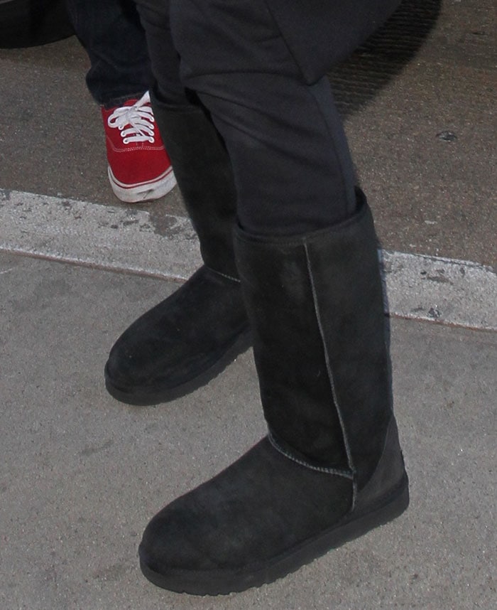 Ciara wearing classic tall UGG boots with black pants