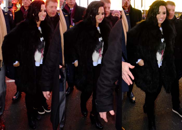 Demi Lovato wears a black fur coat at New York City's Times Square