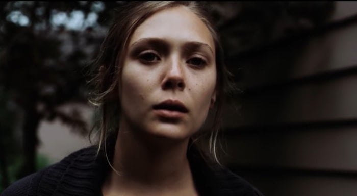 Elizabeth Olsen delivers a haunting performance as Martha, a troubled cult member struggling with her identity, in Martha Marcy May Marlene