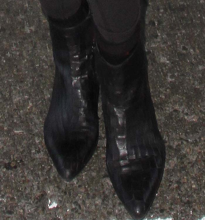 Gigi Hadid strolls through LAX in Stuart Weitzman Zepher boots