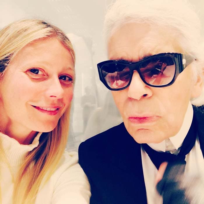 Gwyneth Paltrow shares a candid moment with the iconic Karl Lagerfeld, capturing their close connection during Paris Fashion Week