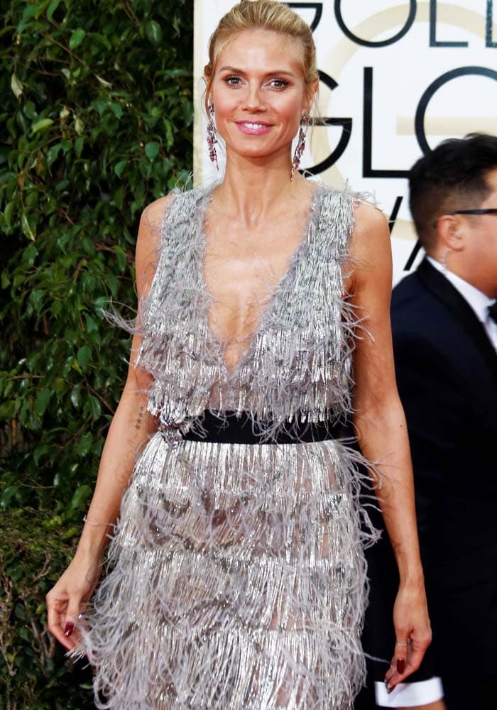 Heidi Klum sparkles in a flapper-style silver Marchesa dress