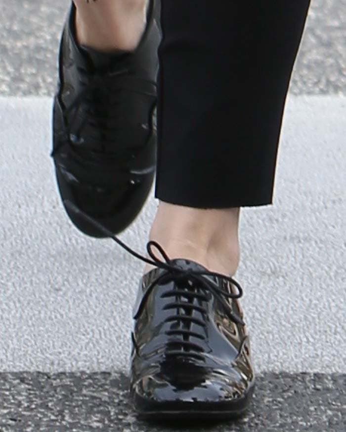 Hilary Duff's feet in black patent Chanel oxfords