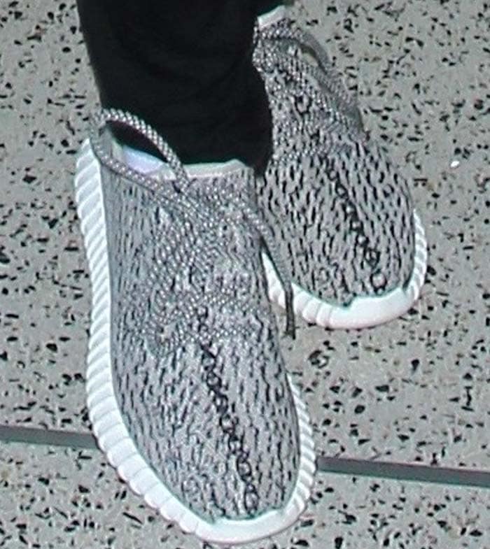 Jada Pinkett-Smith wears a pair of gray Adidas Yeezy sneakers at LAX