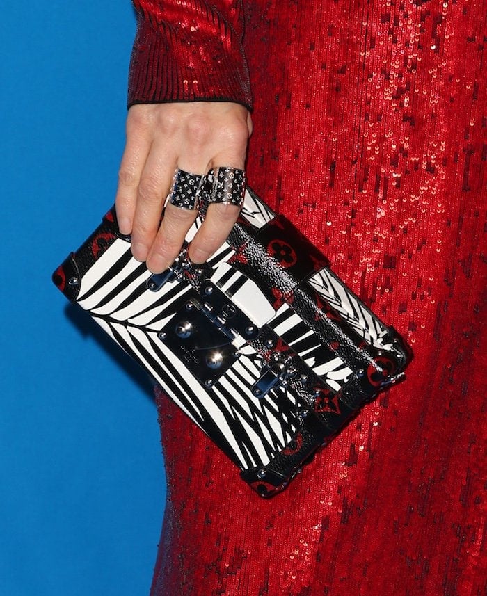 Jennifer Connelly wears Louis Vuitton rings and holds a Louis Vuitton clutch