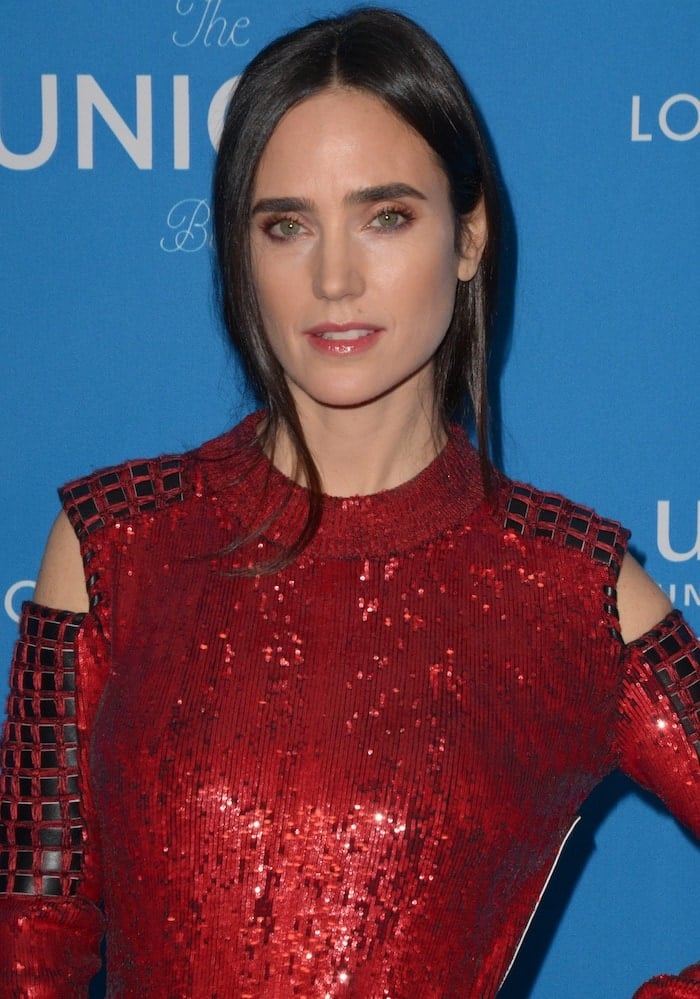 Jennifer Connelly shines in a custom red sequined Louis Vuitton gown with cold-shoulder detailing at the 6th Biennial UNICEF Ball