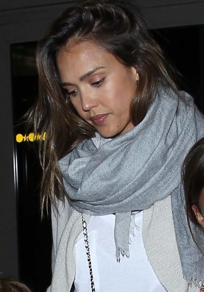 Jessica Alba wears her hair down as she arrives at Los Angeles International Airport