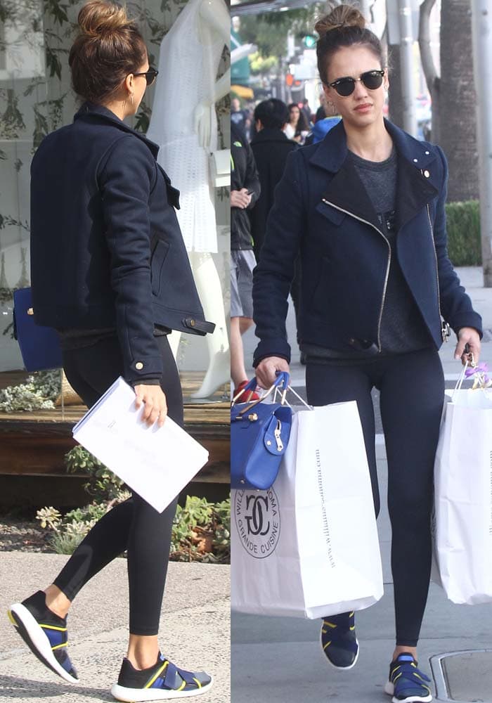 Jessica Alba carries a Williams-Sonoma bag while strolling through Beverly Hills in a navy leather jacket