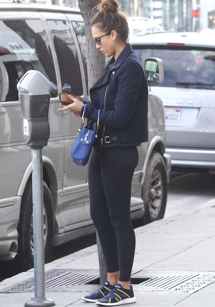 Jessica Alba pays for a parking meter in a black-and-navy post-workout look