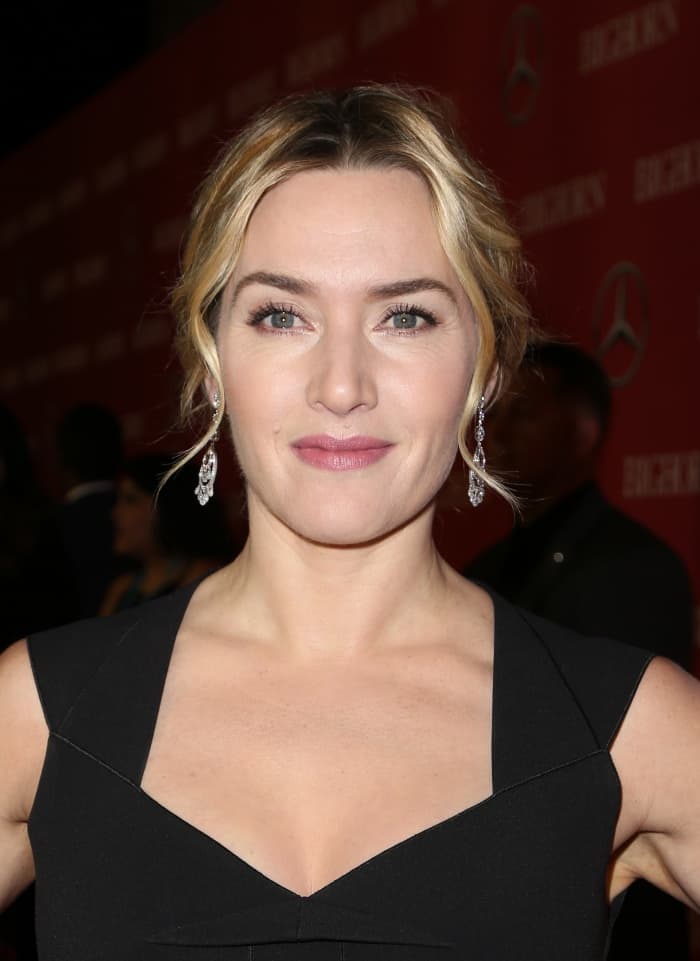 Kate Winslet completed her elegant look with sparkling chandelier earrings and a soft, low chignon that highlighted her natural beauty