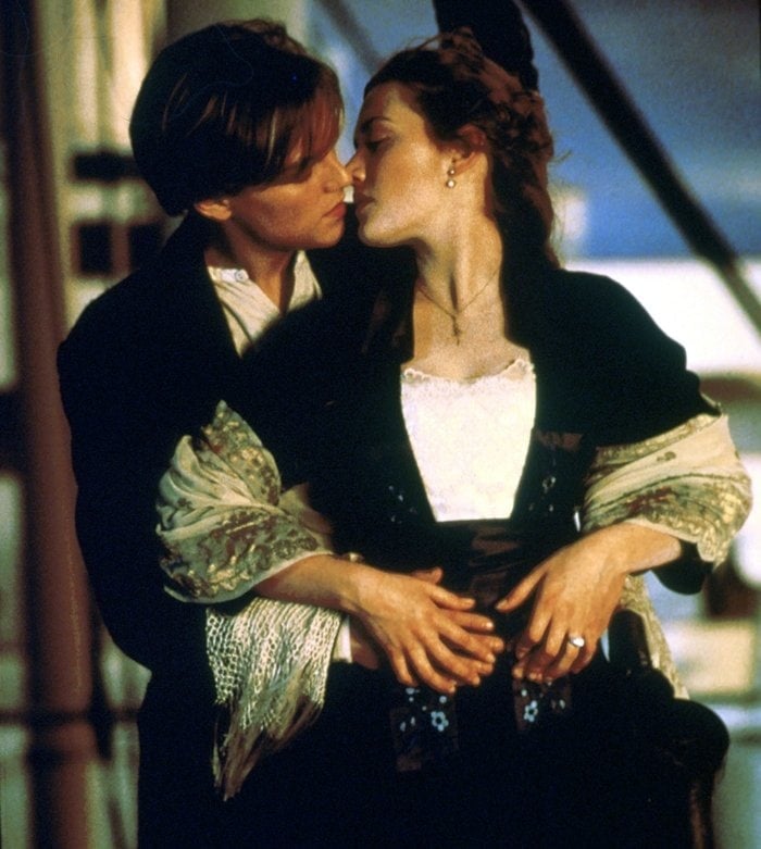 Leonardo DiCaprio and Kate Winslet as members of different social classes who fall in love aboard the Titanic