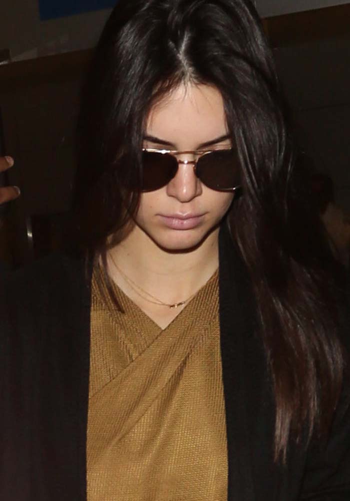 Kendall Jenner wears her hair down as she arrives at Los Angeles International Airport