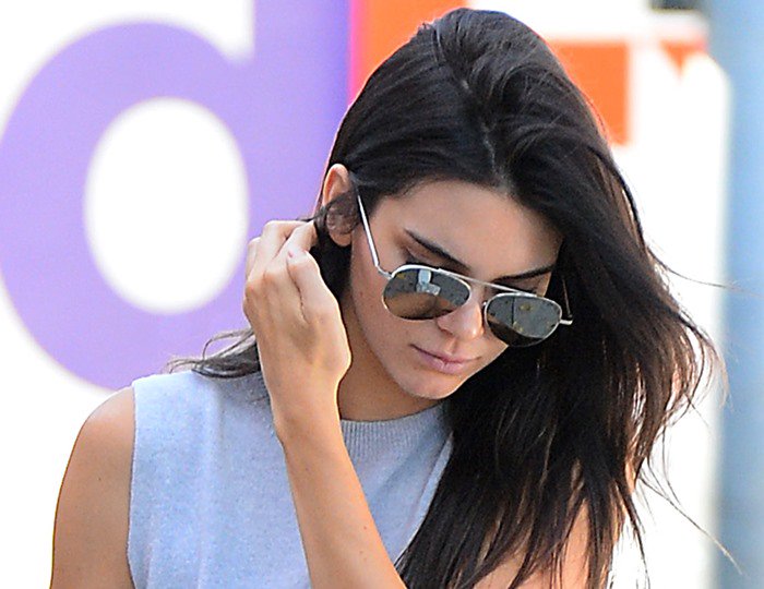 Kendall Jenner pushes her hair back as she leaves Cafe Zinqué in Los Angeles