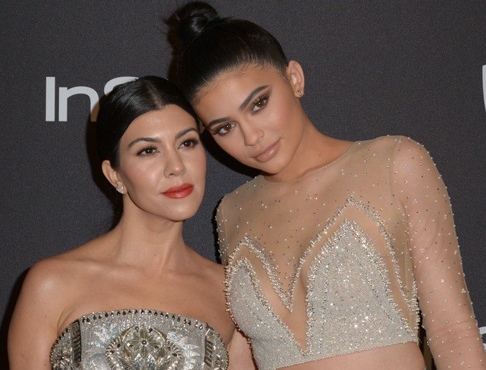 Kourtney Kardashian and her sister Kylie Jenner pose for photos at the Golden Globes after-party