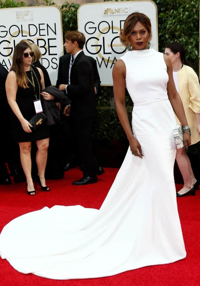 Laverne Cox wearing a custom-made white Elizabeth Kennedy gown on the red carpet of the Golden Globes held at the Beverly Hilton Hotel on January 10, 2016 in Beverly Hills, California