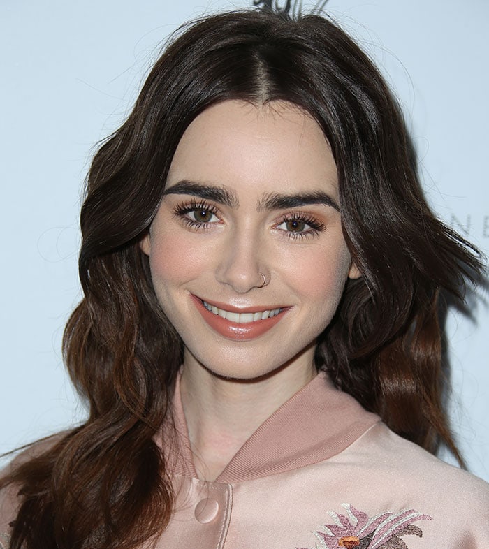 Lily Collins shows off her signature eyebrows with her hair down