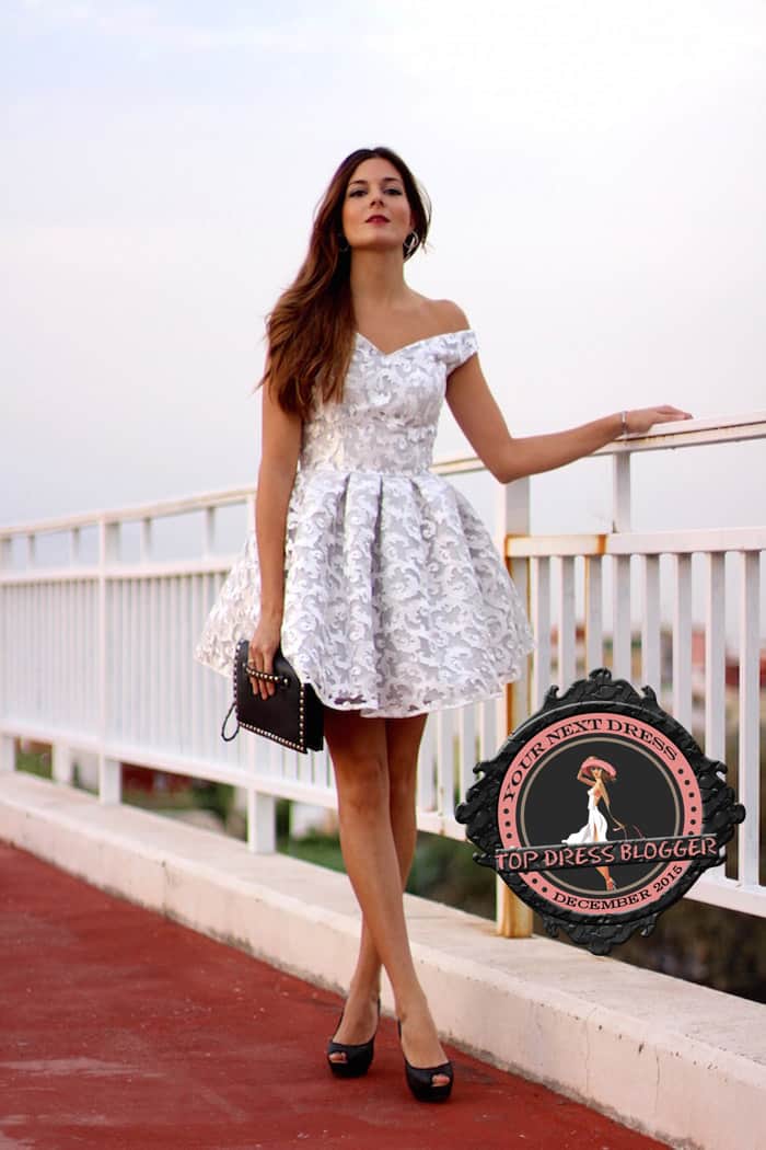 Marianela in a flirty yet elegant white lace dress with black peep-toe pumps